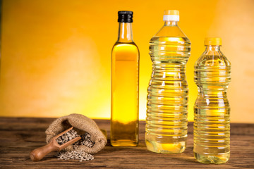 Sunflower oil in a bottle and sunflower flowers and sunflower seeds in a sack