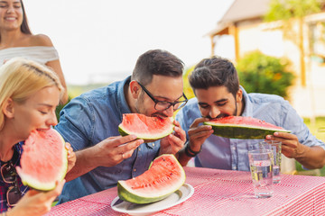 People eating watermelon