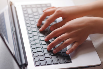 Fototapeta na wymiar Woman working at home office hand on keyboard close up