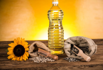 Sunflower oil in a bottle and sunflower seeds and sunflower