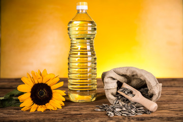 Sunflower oil in a bottle and sunflower seeds and sunflower