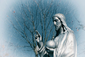 Fragment of statue Jesus Christ. He holds the sphere with a cross as a symbol of the trusteeship of Christianity above the earth. Special effect (faith concept)
