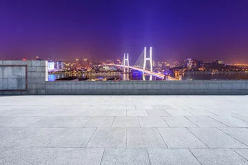 Cercles muraux Pont de Nanpu Empty square floor and bridge buildings at night in Shanghai,China