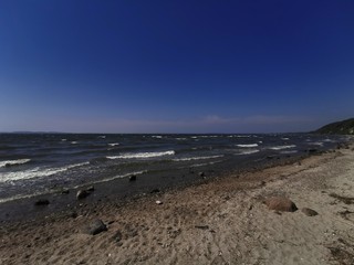 the beach with waves and sunshine