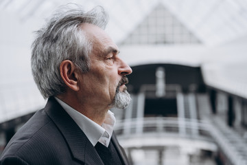 Portrait of man in big office centre thinking of future, investments and ideas