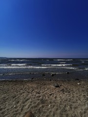 the beach with waves and sunshine