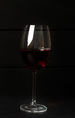 wine glass with red wine on a stone background