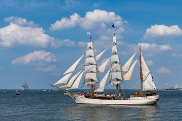 Obraz na płótnie Canvas Antique tall ship, vessel leaving the harbor of The Hague, Scheveningen under a sunny and blue sky