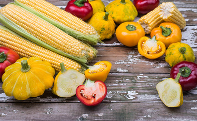 Fresh organic vegetables for cooking vegetarian food on a wooden background.