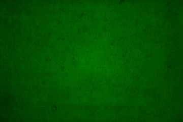 Fototapeta na wymiar Dark edged green background overlaid with grungy elements