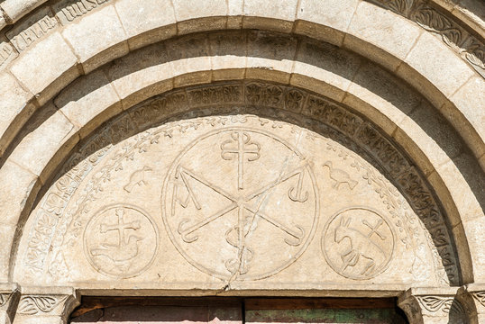 France, Pyrenees National Park, Val d'Azun, Aucun, Roman great door of the church (Monument historique, French designation given to some national heritage sites), chrismons surrounded by the paschal lamb and birds
