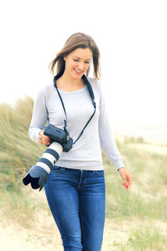 Young woman taking pictures at the beach