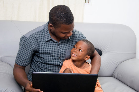 The father is happy to see his child to know and work with a laptop.