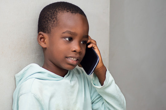 This child on the phone, listening intently his interlocutor.