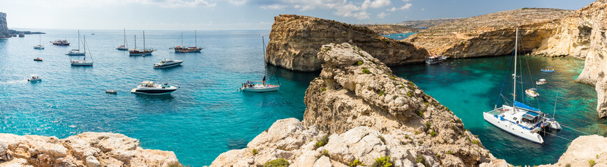 Panorama of Blue Lagoon natural harbour with yachts on island Comino, Malta - obrazy, fototapety, plakaty