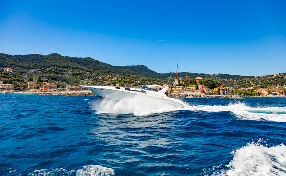Santa Margherita, Cinque Terre, Liguria, Italy - August 11, 2018 - View of a small yacht sailing on the sea in front of the city