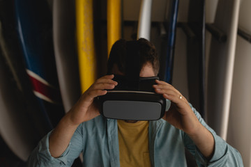 Man holding virtual reality headset in a workshop