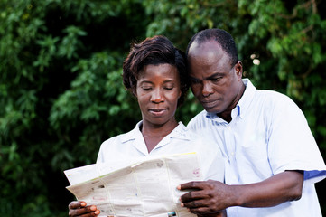 happy young couple traveling consult a regional map.