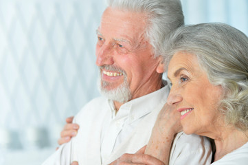 Close up portrait of happy beautiful senior couple posing at home