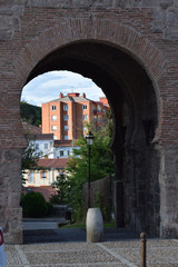Vista de la ciudad a través de la puerta de una muralla.