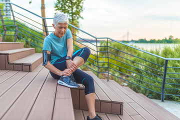 Woman touching her thigh because of pain. Running injury leg accident- sport woman runner hurting...