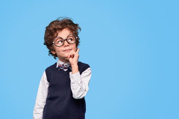 Thoughtful schoolboy looking away