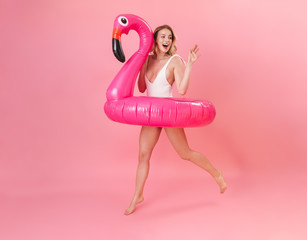 Happy pretty young girl wearing swimsuit standing