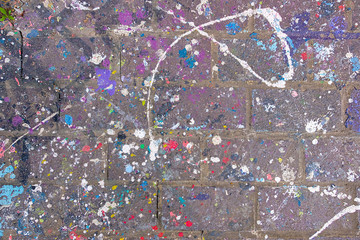 Colorful Paint Splattered and Dripped on old Bricks and Mortar surface