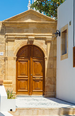 Wooden door in traditional Greek house in historic village of Lindos on Rhodes island. Greece. Europe
