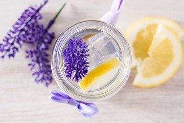 Lavender lemonade drink on white wooden table. Top view