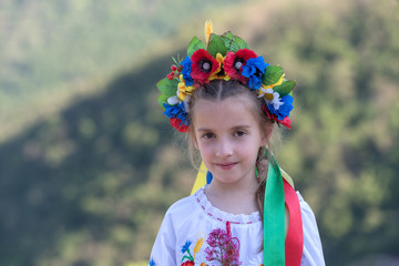 Girl in Ukrainian national dress posing in countryside