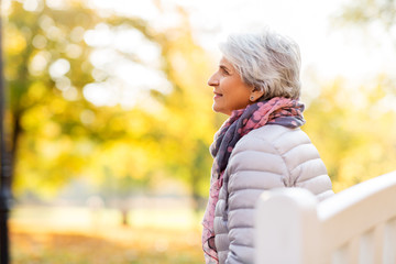 old age, retirement and people concept - portrait of happy senior woman at autumn park