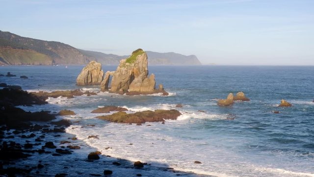 Video of sunny morning at rocky coast near San Juan de Gaztelugatxe, Spain.