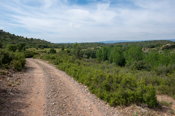 Fototapeta na wymiar Rural road between mountains of the Sierra de Gudar, Valbona
