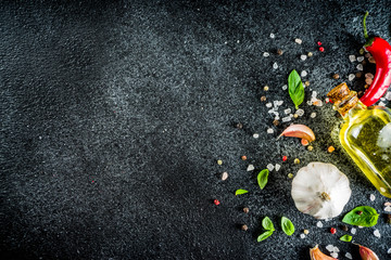 Cooking food stone concrete background with spices, olive oil, garlic, onion, pepper, herbs, basil. Top view copy space