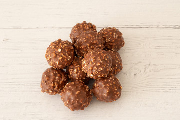 A Pile Of Nutty Chocolate Ice Cream Balls on Course White painted Boards