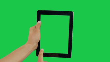 Pointing Finger Clicking On Bottom Left Device Screen with Green Background. Digital Tablet Green Screen. Use in any project that depicts finger, gesture, touchscreen and the like.