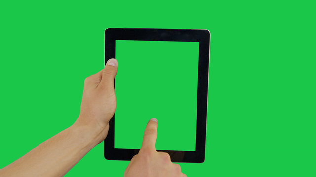 Pointing Finger Clicking On Center Device Screen with Green Background. Digital Tablet Green Screen. Use in any project that depicts finger, gesture, touchscreen and the like. - Powered by Adobe