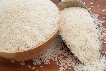 Rice in bowl and scoop on table close up