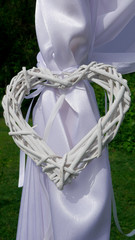 Tethered wattle white heart on a wedding arch - close up
