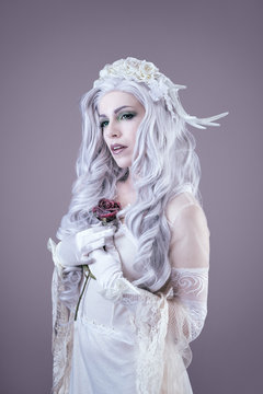 Young princess holding a rose in her hands