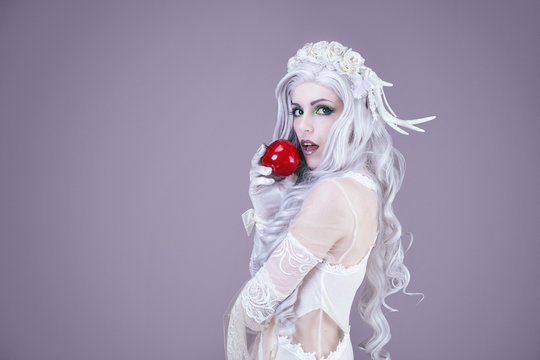Young princess holding an apple in her hand