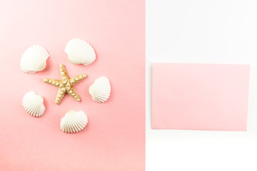Flat lay top view Pink envelope, seashells on a pink background. Summer tropical vacation background. 