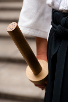 Man in a&iuml;kido gear holding a wood made boken, Tokyo, Japan