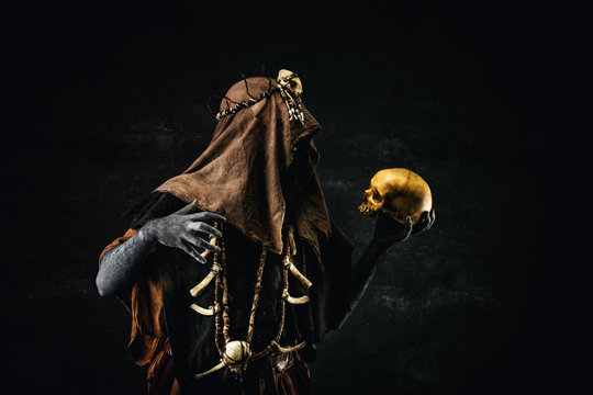 Portrait of a shaman holding a human skull