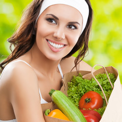  happy smiling dark haired girl in fitness wear with vegetarian food