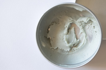 Close-up eco-friendly deodorant cream in metal container on white background