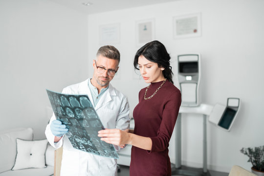 Businesswoman Listening To Plastic Surgeon Before Nasal Surgery