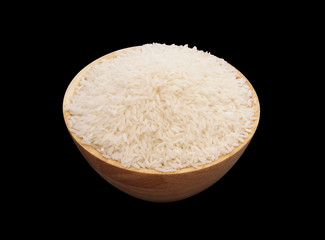 Rice in wooden bowl isolated on black