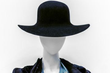 black woman's hat on mannequin white head in a mall